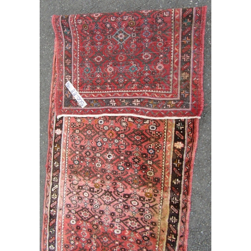 1812 - A Hamadan runner with a repeating geometric pattern on a predominantly pink ground, 500cm x 88cm.