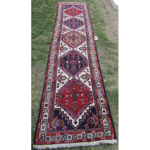 1808 - A Malayer runner with diamond shaped medallions with geometric patterns in blues and reds, 297cm x 8... 