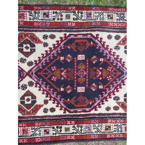 1808 - A Malayer runner with diamond shaped medallions with geometric patterns in blues and reds, 297cm x 8... 