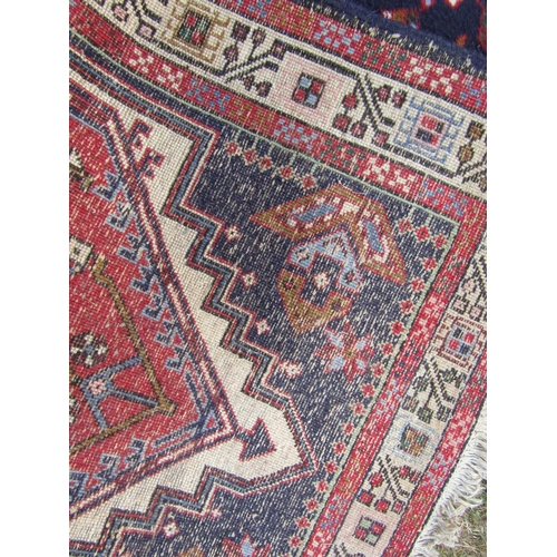 1808 - A Malayer runner with diamond shaped medallions with geometric patterns in blues and reds, 297cm x 8... 