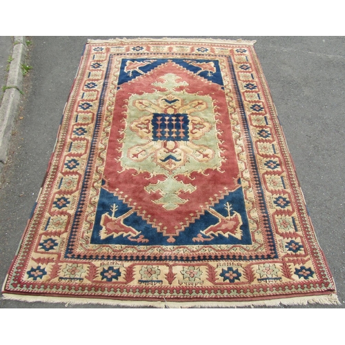 1820 - A Kazak carpet with good thick wool pile in with central medallion in hues of pink , green and blues... 