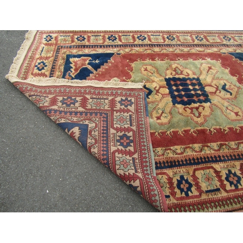 1820 - A Kazak carpet with good thick wool pile in with central medallion in hues of pink , green and blues... 