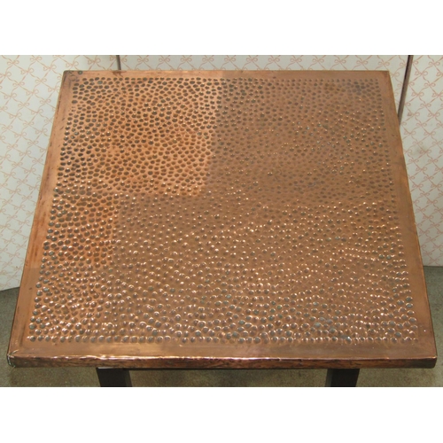 1292 - An arts and crafts style oak occasional table with beaten copper clad square top, raised on square c... 