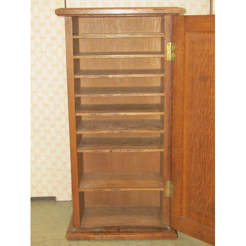 1308 - A late Victorian oak hanging wall cupboard, enclosed by a rectangular panelled door, with shelved in... 