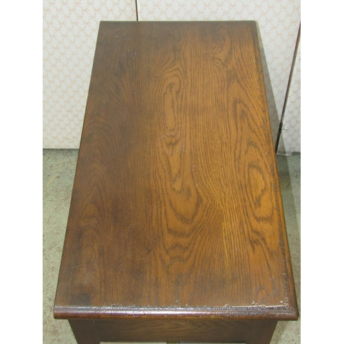 1321 - A good quality reproduction oak side table with distressed finish, fitted with three frieze drawers,... 