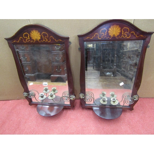 1584 - A pair of Edwardian mahogany wall mirrors, each supporting a pair of brass candle scones, with shell... 