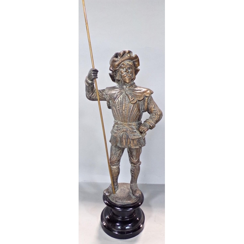 702 - A gold finished spelter figure of a Yeoman holding a staff raised on a socle base. 51cm max.