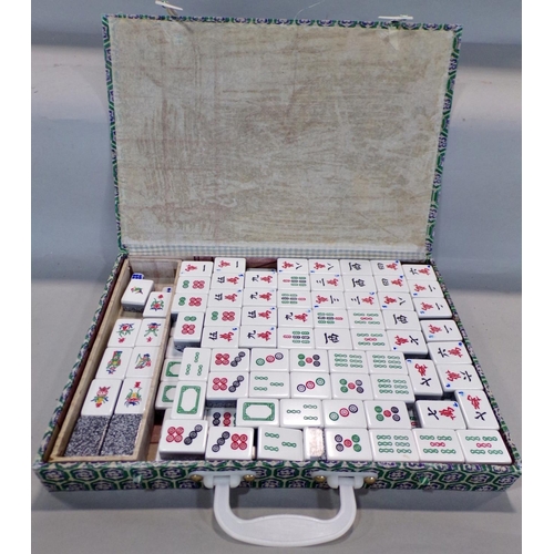 704 - A Mahjong game in a silk lined cardboard box with composite tiles.