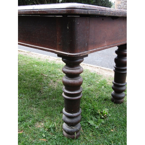 1249 - A substantial Victorian oak table, the rectangular top with moulded outline and rounded corners over... 