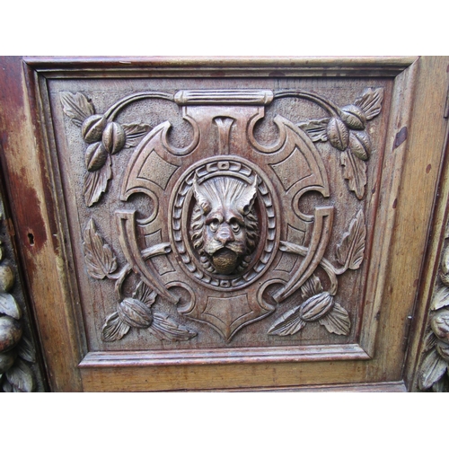 1338 - A Victorian carved oak buffet with lions mask, trailing fruit, vine, geometric and further detail, f... 