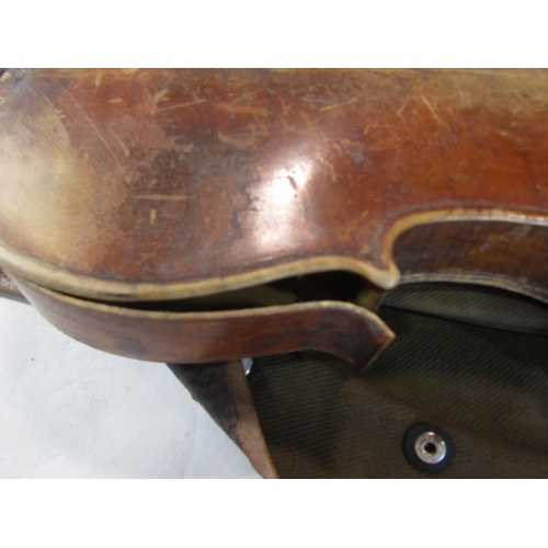 808 - A violin, in need of restoration, with a distressed unreadable label to the interior with a Tourte M... 