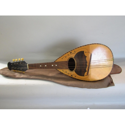 810 - An eight string Mandolin , missing four strings, with a canvas bag.