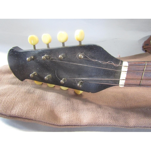 810 - An eight string Mandolin , missing four strings, with a canvas bag.