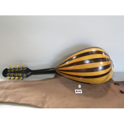 810 - An eight string Mandolin , missing four strings, with a canvas bag.