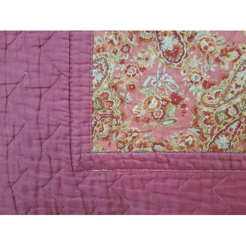 604 - Vintage reversible machine stitched quilt, with blocks of pink contrasted with multicoloured paisley... 