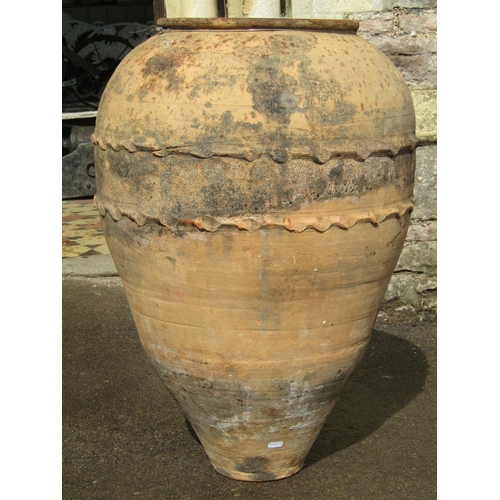 1091 - An old weathered terracotta ovi-form olive jar with thumb pressed bands, 74cm high