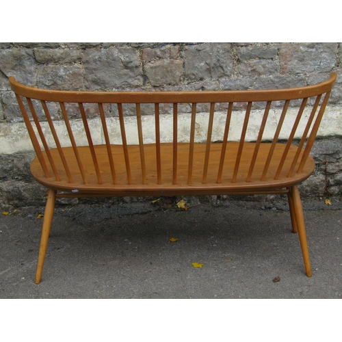 1172 - An Ercol light elm and beechwood loveseat/bench the raised simple stick back with curved moulded rai... 