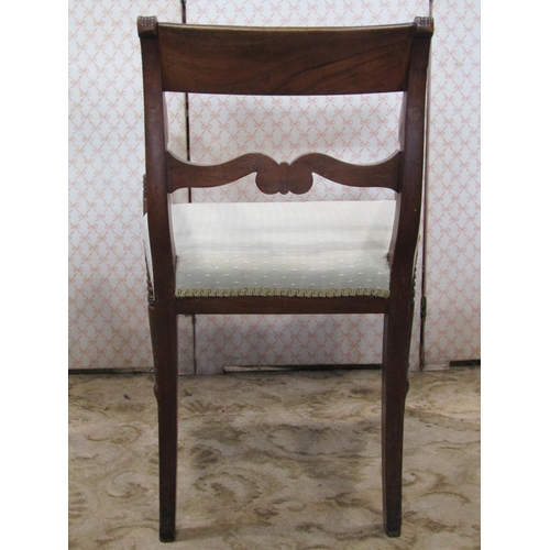 1351 - A Regency mahogany bar back carver chair with reeded splat and down swept open arms over an upholste... 