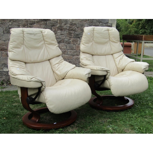 1374 - A pair of Ekorness Stressless lounge chairs with cream soft leather stitched upholstery