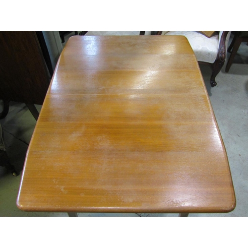 1385 - A mid 20th century walnut veneered and beechwood pull out extending dining table of rectangular form... 