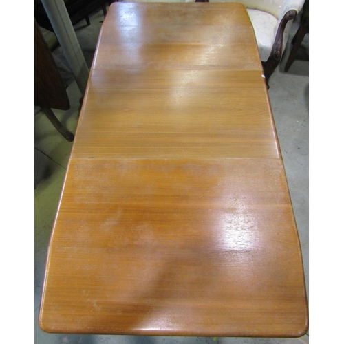 1385 - A mid 20th century walnut veneered and beechwood pull out extending dining table of rectangular form... 