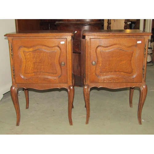 1397 - An oak kneehole dressing table with central frieze drawer flanked by cupboards enclosed by fielded p... 