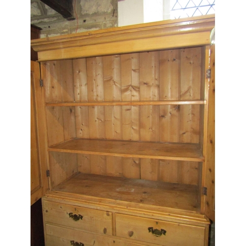 1399 - A 19th century stripped pine linen cupboard in two sections, the upper enclosed by a pair of rectang... 