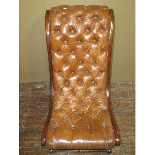 1523 - A Regency style mahogany framed drawing room chair with swept outline, upholstered in buttoned brown... 