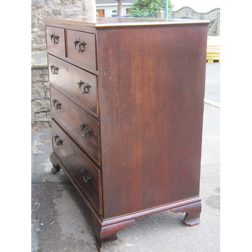 1573 - A mid-Georgian period mahogany chest of three long and two short graduated drawer, raised on ogee su... 