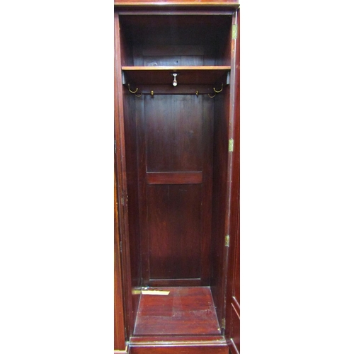 1576 - A good quality Edwardian mahogany breakfront wardrobe enclosed by a central mirror panelled door wit... 