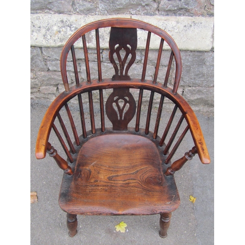 1581a - A Georgian hoop back elbow chair in mixed woods including elm, yew, etc with pierced splat