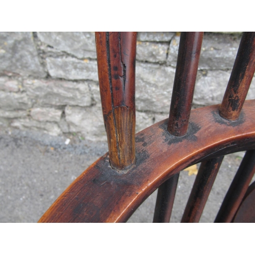 1581a - A Georgian hoop back elbow chair in mixed woods including elm, yew, etc with pierced splat