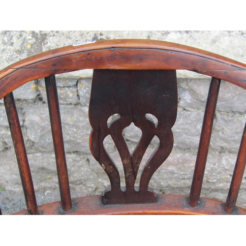 1581a - A Georgian hoop back elbow chair in mixed woods including elm, yew, etc with pierced splat