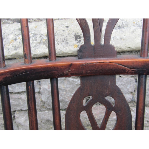 1581a - A Georgian hoop back elbow chair in mixed woods including elm, yew, etc with pierced splat