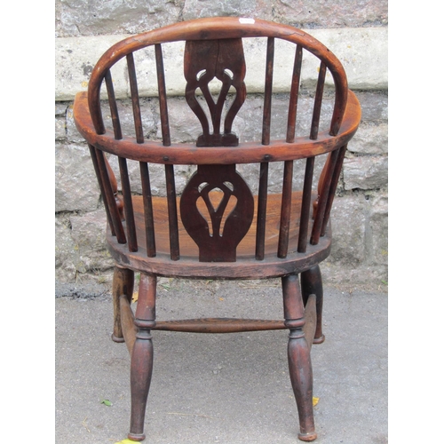 1581a - A Georgian hoop back elbow chair in mixed woods including elm, yew, etc with pierced splat