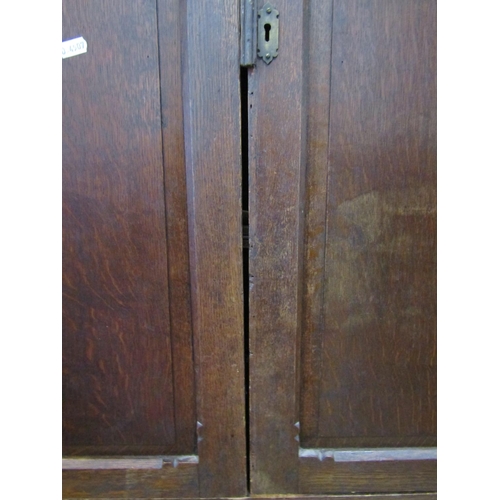 1341 - A 19th century oak side cupboard, freestanding and enclosed by a pair of rectangular fielded panelle... 