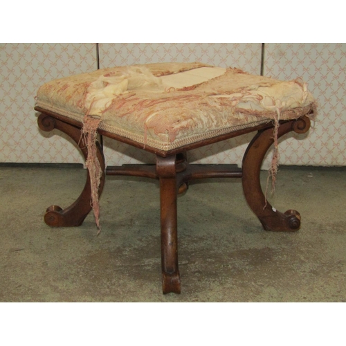 1364 - A Victorian mahogany stool with square upholstered seat raised on C scrolled supports united by an x... 