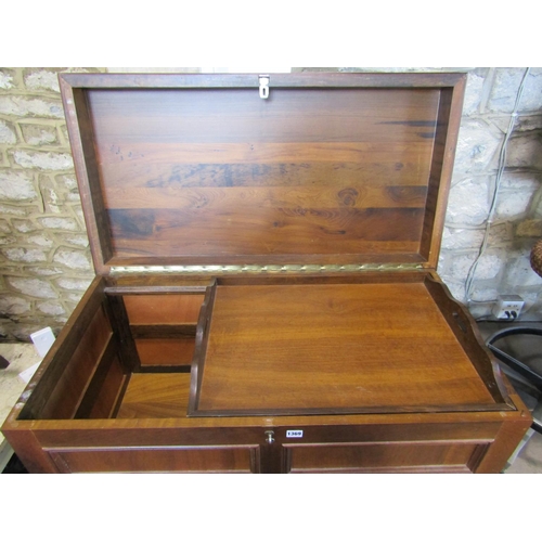 1369 - A walnut coffer with rectangular moulded panelled surround beneath a hinged lid with repeating arche... 