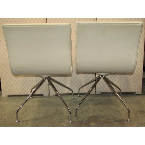 1415 - A pair of Frag 828 swivel chairs with cream stitched leather rolled/contoured upholstery, raised on ... 