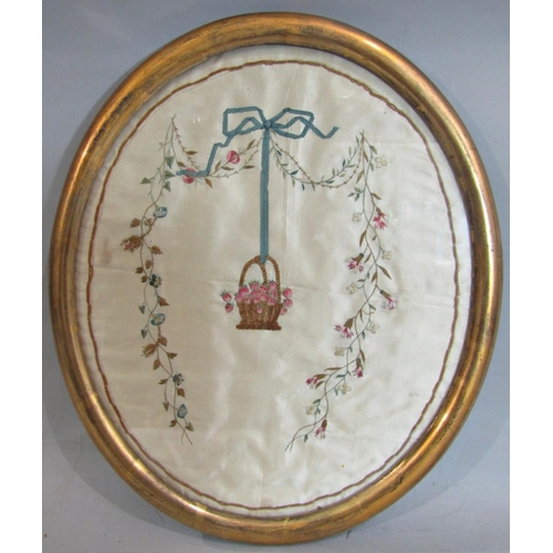 976 - Georgian silk embroidery of basket of flowers and ribbons in glazed gilt oval frame 35 x 40 cm