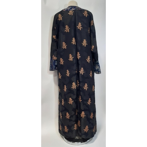 625 - Oriental vintage kimono gown made of patterned black silk embroidered with goldwork characters and l... 