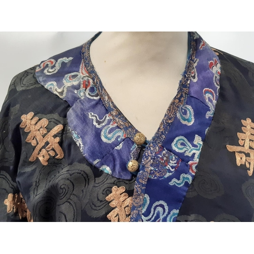 625 - Oriental vintage kimono gown made of patterned black silk embroidered with goldwork characters and l... 