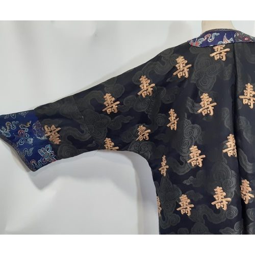 625 - Oriental vintage kimono gown made of patterned black silk embroidered with goldwork characters and l... 