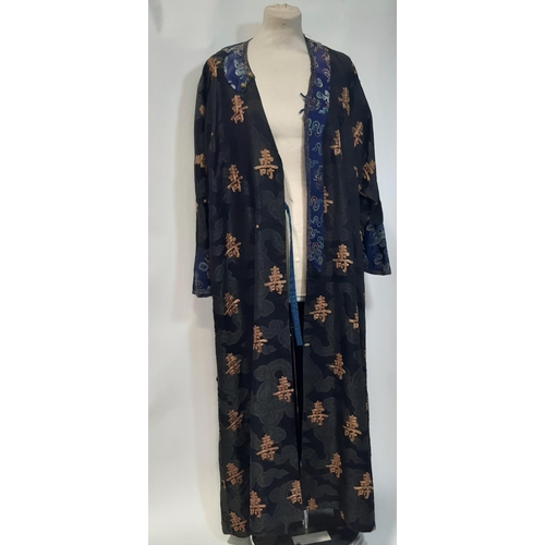 625 - Oriental vintage kimono gown made of patterned black silk embroidered with goldwork characters and l... 