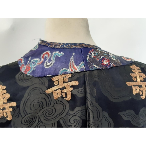 625 - Oriental vintage kimono gown made of patterned black silk embroidered with goldwork characters and l... 