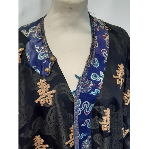 625 - Oriental vintage kimono gown made of patterned black silk embroidered with goldwork characters and l... 