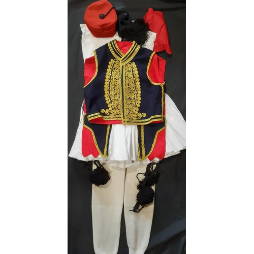 629 - Greek traditional man's costume comprising braided waistcoat, white legwear, red sash, tasselled hat