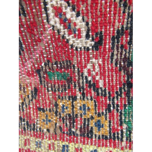 1781 - A large Sarouk design carpet with an all over floral pattern on a red ground, 310cm x 210cm approx