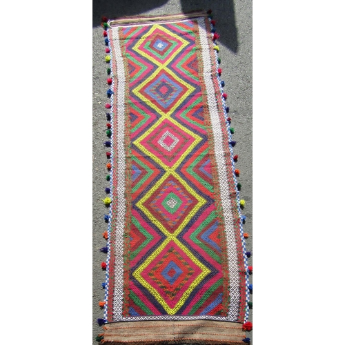 1782 - An old Sunni flat weave runner with brightly coloured panels, 320cm x 82cm approx