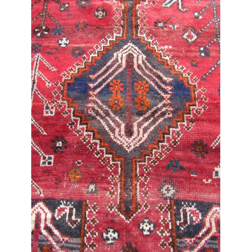 1784 - A Persian rug with stylised birds and flowers and an interlocking medallion on a red ground, 164cm x... 